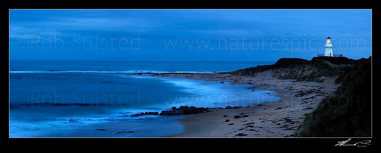 Image of Waipapa Point lighthouse and beach panorama on a moody evening, Fortrose, Southland District, Southland Region, New Zealand (NZ) stock photo image