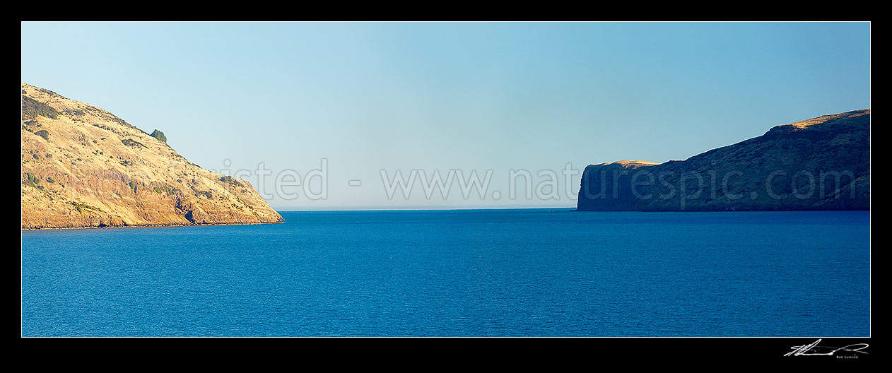 Image of Akaroa Harbour entrance and heads in late afternoon light. Timutimu head at right. Banks Peninsula. Panorama, Akaroa, Christchurch City District, Canterbury Region, New Zealand (NZ) stock photo image