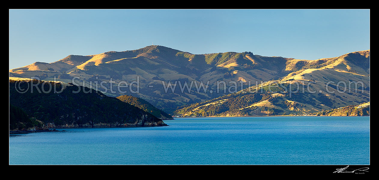 Image of Akaroa upper harbour, looking towards Duvauchelle, Onawe Peninsula and Mt Pearce (737m) from near Wainui. Robinsons bay at right. Banks Peninsula. Panorama, Akaroa, Christchurch City District, Canterbury Region, New Zealand (NZ) stock photo image