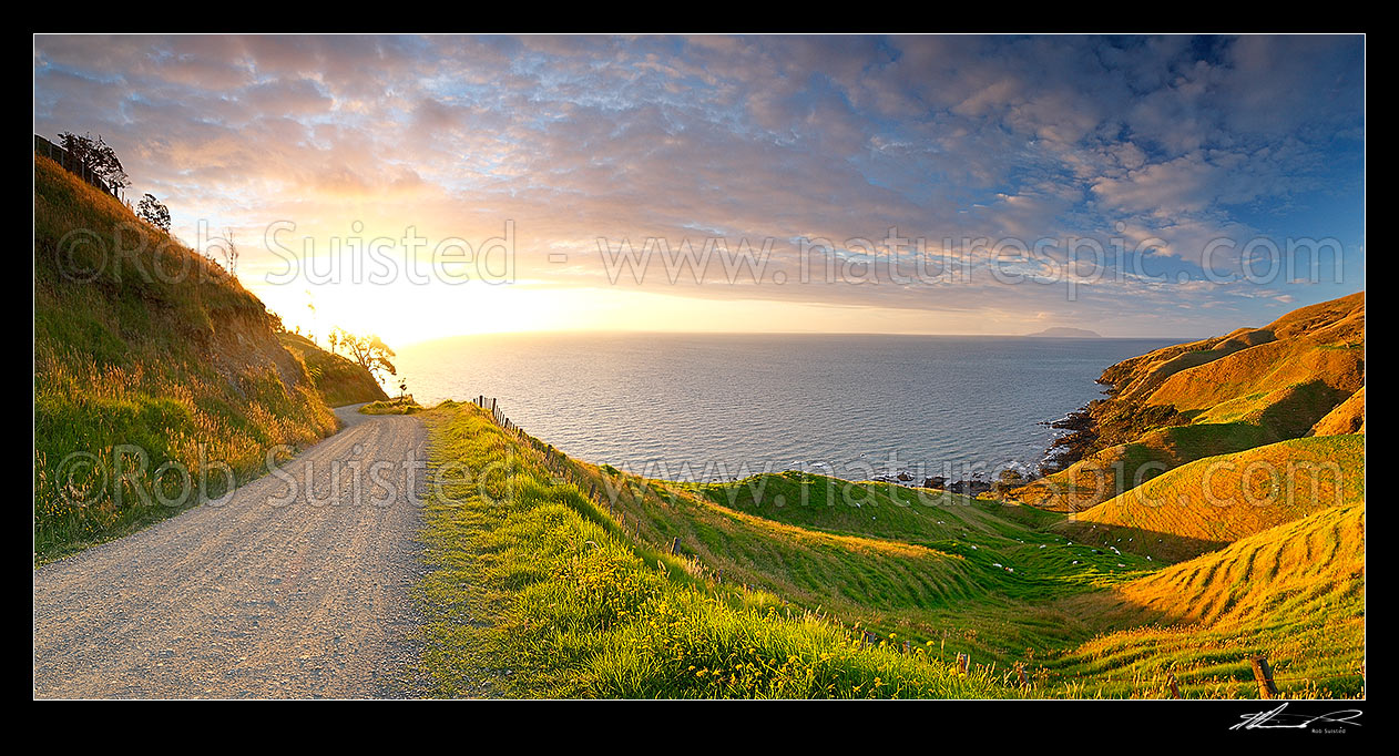 Image of Coromandel panorama looking north from near Cape Colville to Little Barrier Island (Hauturu) on beaut summer evening sunset. Farmland and dirt road, Cape Colville, Thames-Coromandel District, Waikato Region, New Zealand (NZ) stock photo image