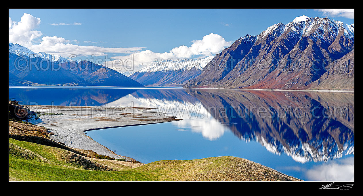 Image of Lake Hawea on a perfect calm spring/winter day reflecting the surrounding snowy ranges, looking towards Huxley Range, Dingle Burn and Hunter valley. Panorama, Lake Hawea, Otago, Queenstown Lakes District, Otago Region, New Zealand (NZ) stock photo image