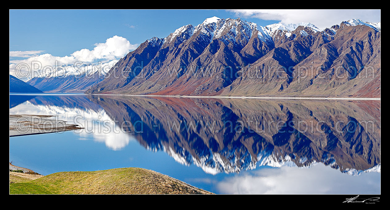 Image of Lake Hawea on a perfect calm spring/winter day reflecting the surrounding snowy ranges, looking towards Huxley Range, Dingle Burn and Hunter valley. Panorama, Lake Hawea, Otago, Queenstown Lakes District, Otago Region, New Zealand (NZ) stock photo image