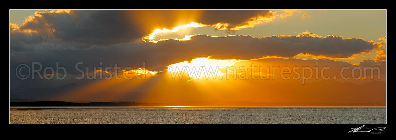 Image of Dramatic sunset over Tasman Bay and Rabbit Island. Panorama, Nelson, Nelson City District, Nelson Region, New Zealand (NZ) stock photo image