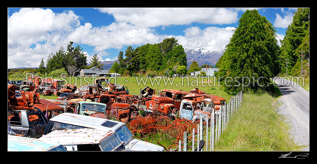 Image of Old car wrecks at Horopito Motors 'Smash Palace', beneath Mount Ruapehu #beyond#. Panorama, Horopito, Ruapehu District, Manawatu-Wanganui Region, New Zealand (NZ) stock photo image