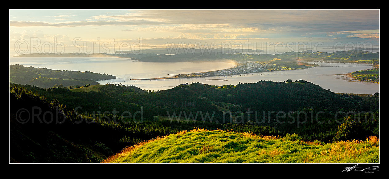 Image of Omaha Beach and Bay. Tawharanui Peninsula and Ti Point left, Whangateau Harbour right, and Kawau Island beyond, at dawn. Panorama, Leigh, Rodney District, Auckland Region, New Zealand (NZ) stock photo image