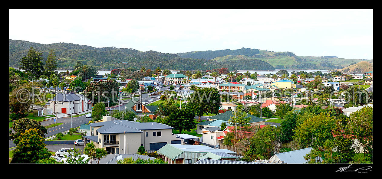 Image of Raglan township, with Wainui Road ending at the historic Harbour View Hotel on Bow Street. Raglan Harbour beyond. Panorama, Raglan, Waikato District, Waikato Region, New Zealand (NZ) stock photo image