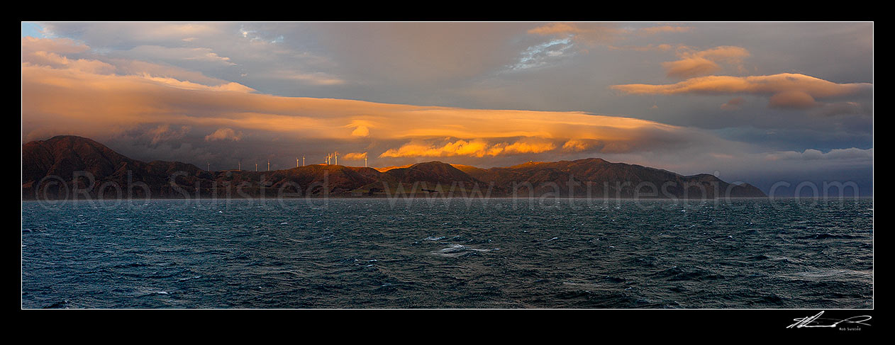 Image of Breaking weather over the Meridian Energys Project West Wind farm turbines on Wellington's South Coast, seen from Cook Strait. Terawhiti coast and station. Panorama, Cape Terawhiti, Wellington City District, Wellington Region, New Zealand (NZ) stock photo image