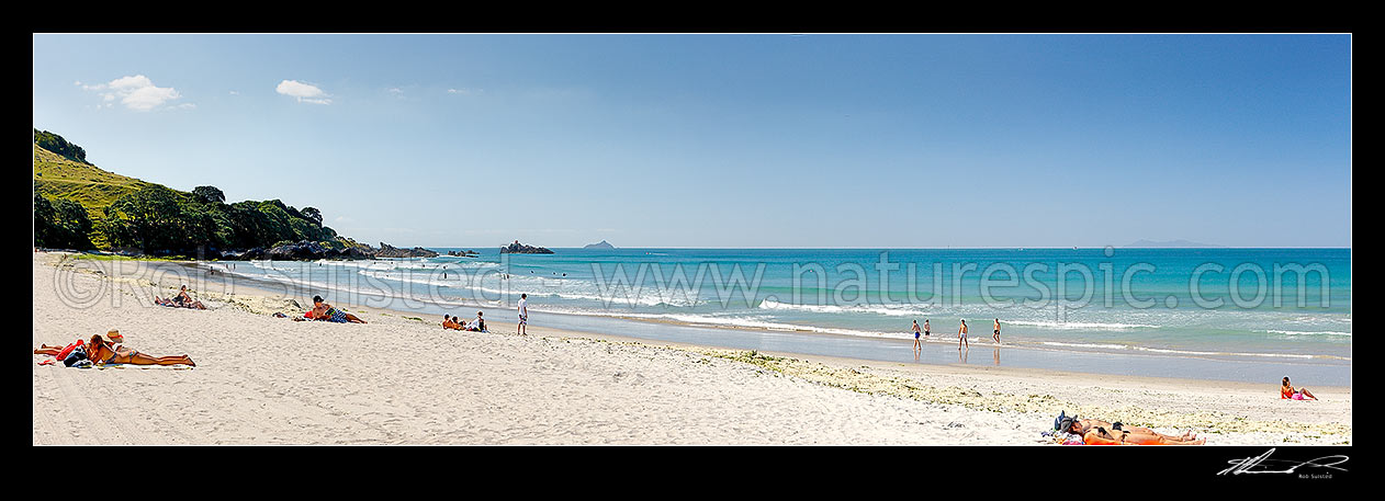 Image of Mount Maunganui beach panorama, with people sunbathing and swimming, and distant Karewa Island (centre) and Mayor Is. (Tuhua - far right), Mount Maunganui, Tauranga District, Bay of Plenty Region, New Zealand (NZ) stock photo image