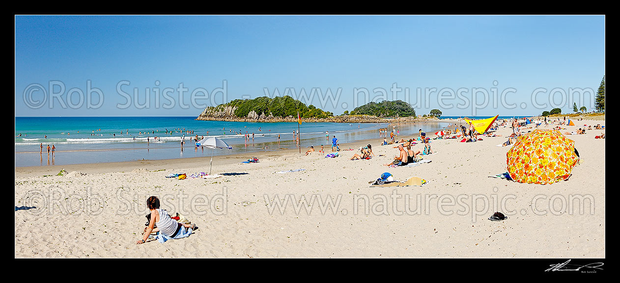 Image of Mount Maunganui beach panorama, with people sunbathing and swimming, with Moturiki and Motuotau Islands behind, Mount Maunganui, Tauranga District, Bay of Plenty Region, New Zealand (NZ) stock photo image