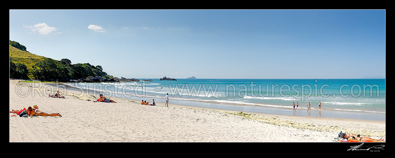 Image of Mount Maunganui beach panorama, with people sunbathing and swimming, and distant Karewa Island (centre) and Mayor Is. (Tuhua - far right), Mount Maunganui, Tauranga District, Bay of Plenty Region, New Zealand (NZ) stock photo image