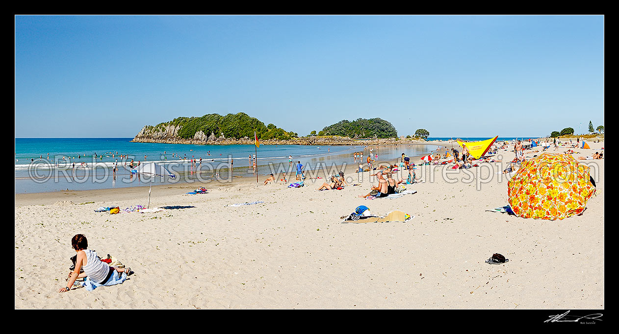 Image of Mount Maunganui beach with people sunbathing and swimming, with Moturiki and Motuotau Islands behind, Mount Maunganui, Tauranga District, Bay of Plenty Region, New Zealand (NZ) stock photo image