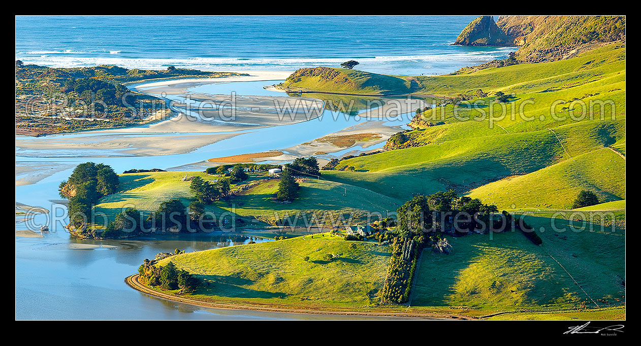 Image of Otago Peninsula farmland, houses and beaches around Hoopers Inlet mouth on a perfect calm later winter morning. Allans Beach left. Panorama, Otago Peninsula, Dunedin City District, Otago Region, New Zealand (NZ) stock photo image