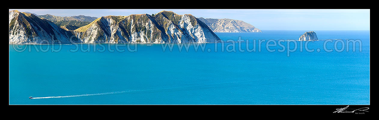 Image of Tolaga Bay. Marau Point visible beyond Te Karaka Point and island. Recreational fishing boat returning. Panorama, Tolaga Bay, Gisborne District, Gisborne Region, New Zealand (NZ) stock photo image