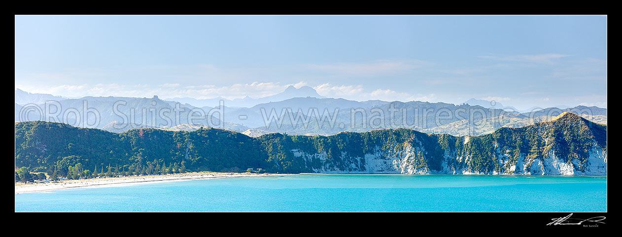 Image of Tolaga Bay with Mount Hikurangi (1752m) and Raukumara Ranges towering distantly beyond. Panorama, Tolaga Bay, Gisborne District, Gisborne Region, New Zealand (NZ) stock photo image