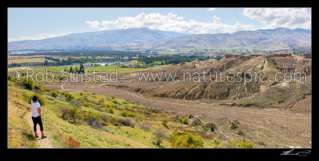 Image of Bannockburn Sluicings Historic Reserve walkway with remains of gold mining and sluicing over 50 years from the early 1860s. Panorama towards Kawarau River and Cromwell, Bannockburn, Central Otago District, Otago Region, New Zealand (NZ) stock photo image