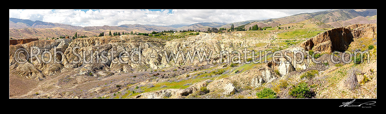 Image of Bannockburn Sluicings Historic Reserve with remains of gold mining and sluicing erosion over 50 years from the early 1860s. Panorama, Bannockburn, Central Otago District, Otago Region, New Zealand (NZ) stock photo image