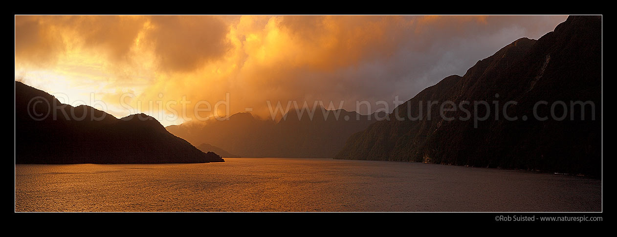 Image of Acheron Passage stormy sunset, looking towards Breaksea Sound. Resolution Island left. Panorama, Breaksea Sound, Fiordland National Park, Southland District, Southland Region, New Zealand (NZ) stock photo image