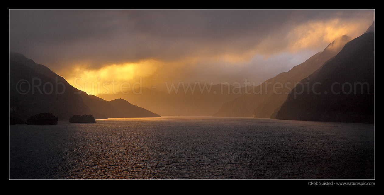 Image of Acheron Passage stormy sunset, looking towards Breaksea Sound. Resolution Island left. Panorama, Breaksea Sound, Fiordland National Park, Southland District, Southland Region, New Zealand (NZ) stock photo image