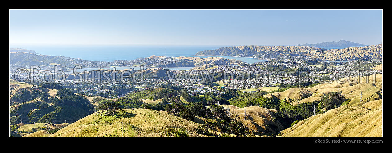 Image of Porirua Harbour panorama. Cannons Creek, Porirua East, Titahi Bay, Paremata, Plimmerton, with Kapiti Island distant. From Belmont Regional Park, Porirua, Porirua City District, Wellington Region, New Zealand (NZ) stock photo image