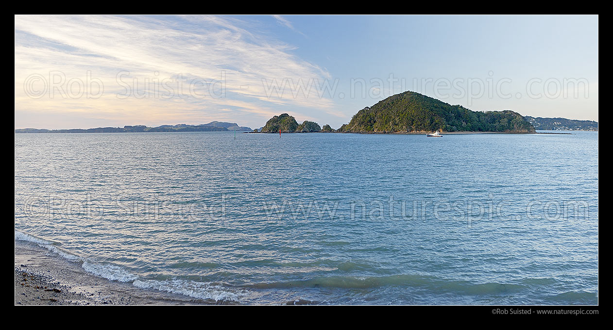 Image of Bay of Islands panorama with Motumaire Island and moored game fishing boat, Pahia, Bay of Islands, Far North District, Northland Region, New Zealand (NZ) stock photo image