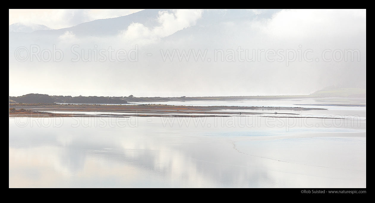 Image of Maori Pa Beach isthmus and lagoon. Delaware Bay, Julias Rescue, coastal hills and distant Bryant Range beyond in lifting mist. Panorama, Cable Bay, Nelson City District, Nelson Region, New Zealand (NZ) stock photo image