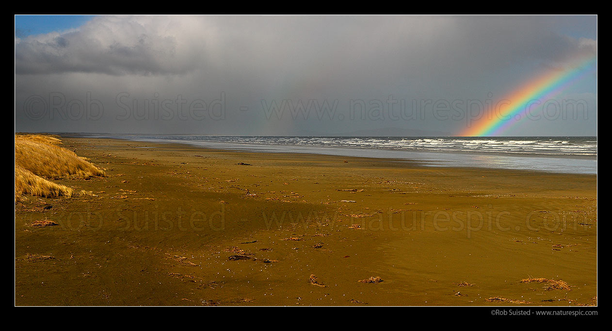 Image of Oreti Beach, sand dunes and rainbow at Waimatuku Stream mouth, between Invercargill and Riverton. Panorama, Oreti Beach, Southland District, Southland Region, New Zealand (NZ) stock photo image