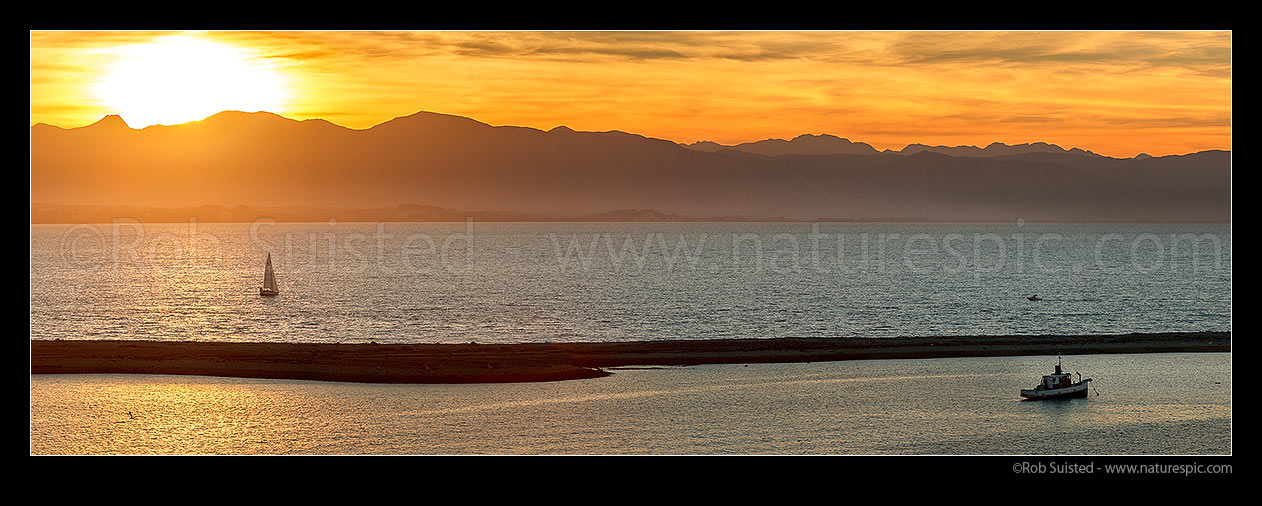 Image of Sailboat sailing on Tasman Bay, beyond The Boulder Bank and Nelson Haven. Kahurangi National Park mountains beyond. Panorama, Nelson, Nelson City District, Nelson Region, New Zealand (NZ) stock photo image