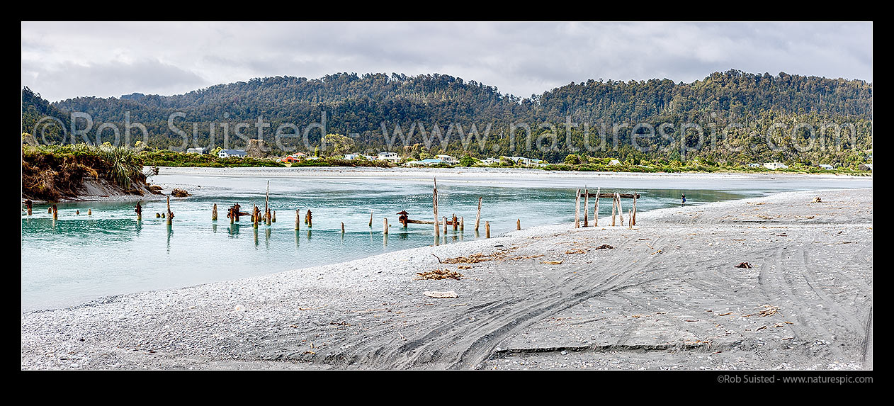 Image of Okarito township by the Lagoon and River mouth. Showing ruins of historic wharf remains built in 1930's by Downers for timber export. South Westland. Panorama, Okarito, Westland District, West Coast Region, New Zealand (NZ) stock photo image