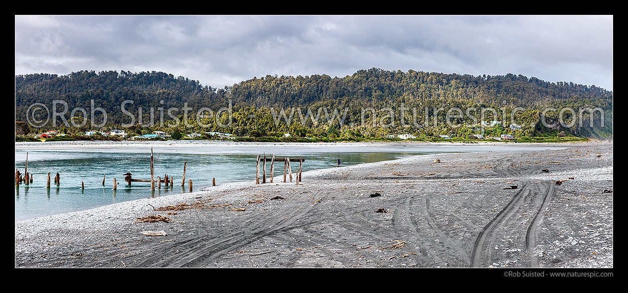 Image of Okarito township by the Lagoon and River mouth. Showing ruins of historic wharf remains built in 1930's by Downers for timber export. South Westland. Panorama, Okarito, Westland District, West Coast Region, New Zealand (NZ) stock photo image