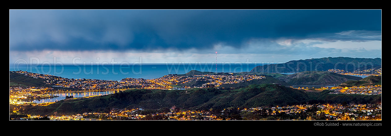 Image of Porirua City (left) and Harbour at twilight. Porirua East and Cannons Creek in foreground, Takapuwahia and Titahi Bay and Cook Strait beyond, with Aotea, and Plimmerton at right. Panorama, Porirua, Porirua City District, Wellington Region, New Zealand (NZ) stock photo image