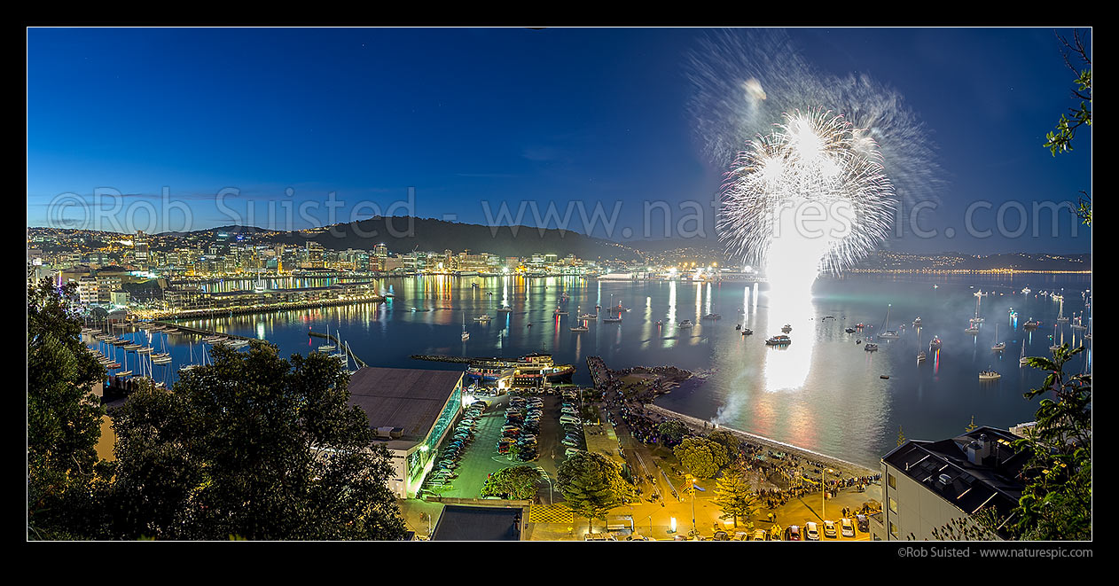 Image of Fireworks in Wellington City off Oriental Bay with spectators lining the shore or in private boats. Panorama, Wellington, Wellington City District, Wellington Region, New Zealand (NZ) stock photo image