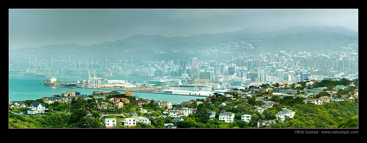 Image of Wellington City and harbour with approaching southerly weather front and storm. Khandallah suburb foreground. City suburbs, CBD, Port, Westpac Stadium beyond. Panorama, Wellington, Wellington City District, Wellington Region, New Zealand (NZ) stock photo image