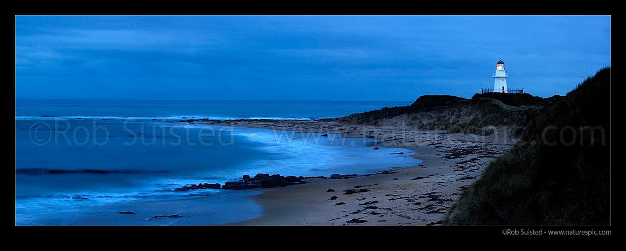 Image of Waipapa Point lighthouse and beach panorama on a moody evening, Fortrose, Southland District, Southland Region, New Zealand (NZ) stock photo image