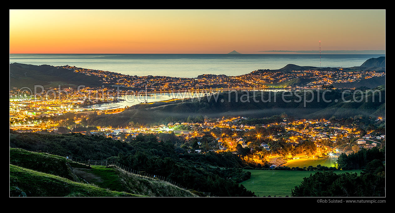 Image of Porirua City with Mt Taranaki visible on horizon. Porirua CBD left, Titahi Bay centre, Porirua East right. Twilight panorama, Porirua, Porirua City District, Wellington Region, New Zealand (NZ) stock photo image