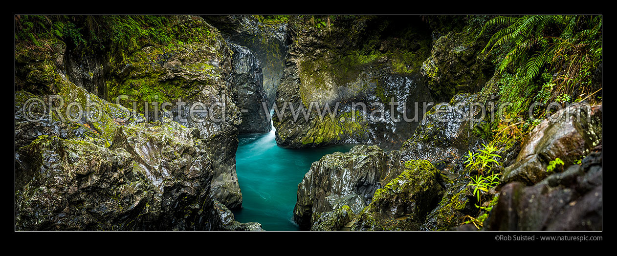 Image of Tongariro River in rugged water worn basalt rock gorge with moss and ferns. Wide panorama, Kaimanawa Forest Park, Taupo District, Waikato Region, New Zealand (NZ) stock photo image