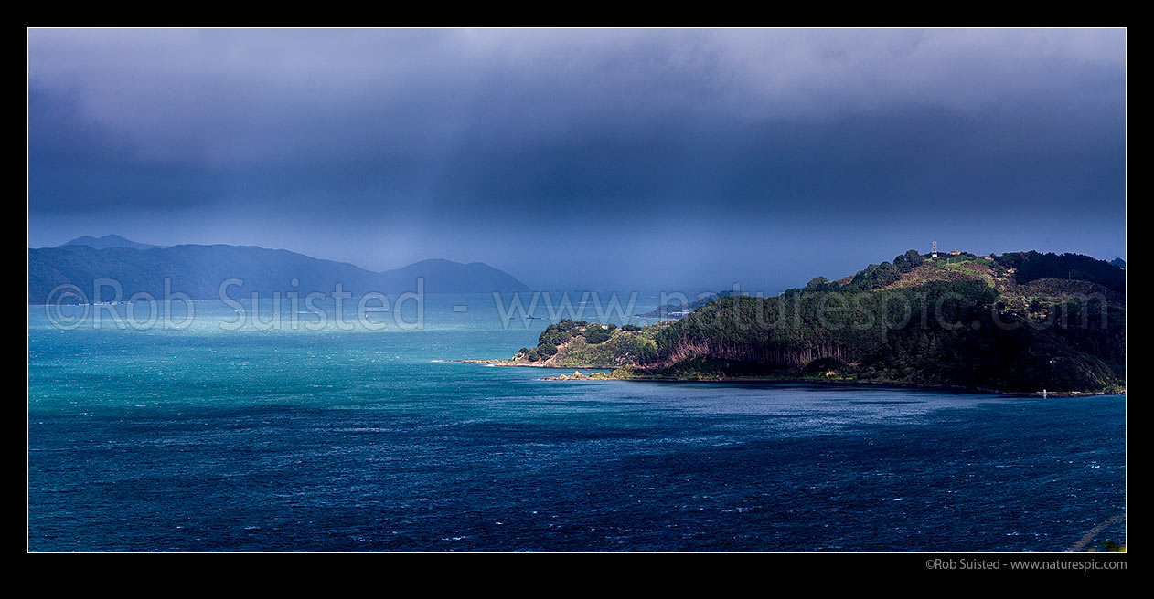 Image of Wellington Harbour entrance with breaking weather after a cold southerly front. First rays of sun. Miramar Peninsula and Mt Crawford far right. Panorama, Wellington Harbour, Wellington City District, Wellington Region, New Zealand (NZ) stock photo image