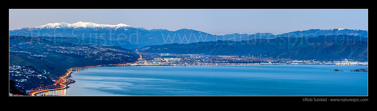 Image of Hutt Valley, City and Petone below snowy Tararua Ranges at dusk. SH1, SH2 & Korokoro at left, Seaview, Gracefield, & Remutaka (Rimutaka) Ranges right. Panorama, Wellington, Wellington City District, Wellington Region, New Zealand (NZ) stock photo image