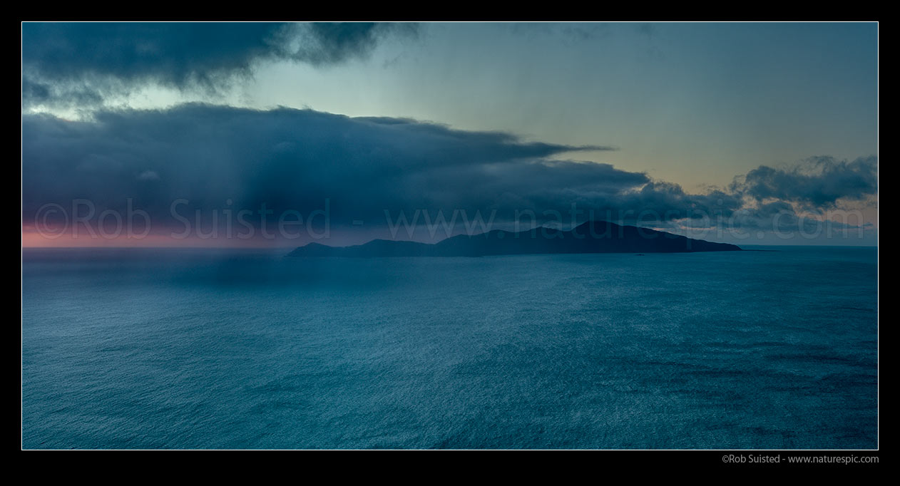 Image of Kapiti Island with sleety winter rain showers moving in from Cook Strait on a moody evening, Paekakariki, Kapiti Coast District, Wellington Region, New Zealand (NZ) stock photo image