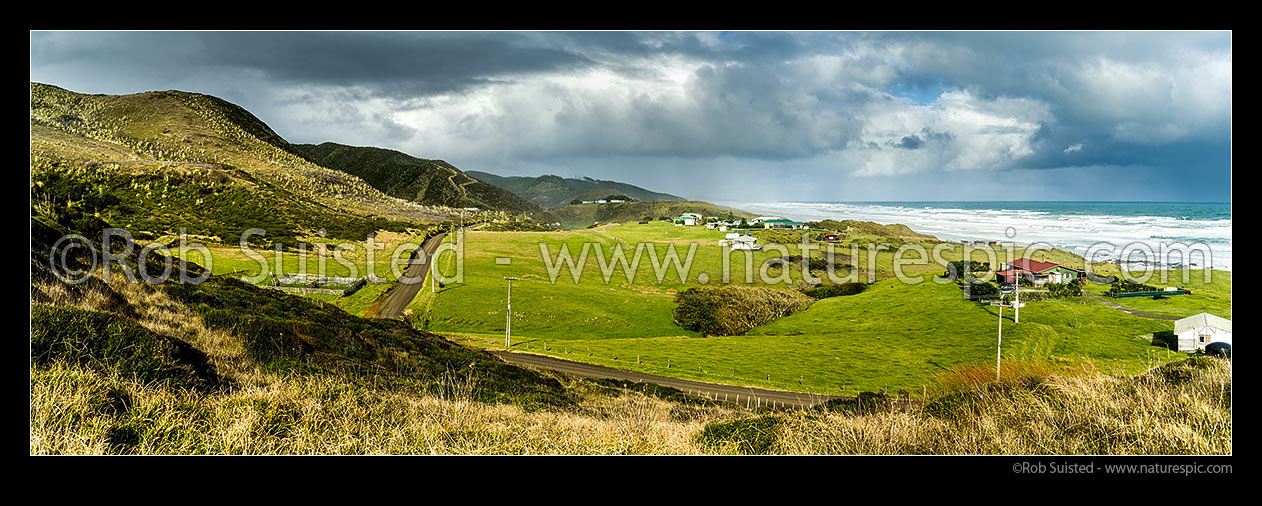 Image of Mitimiti farmland and houses overlooking Mitimiti beach and weather breaks on the wild west coast. Panorama, Mitimiti, Far North District, Northland Region, New Zealand (NZ) stock photo image