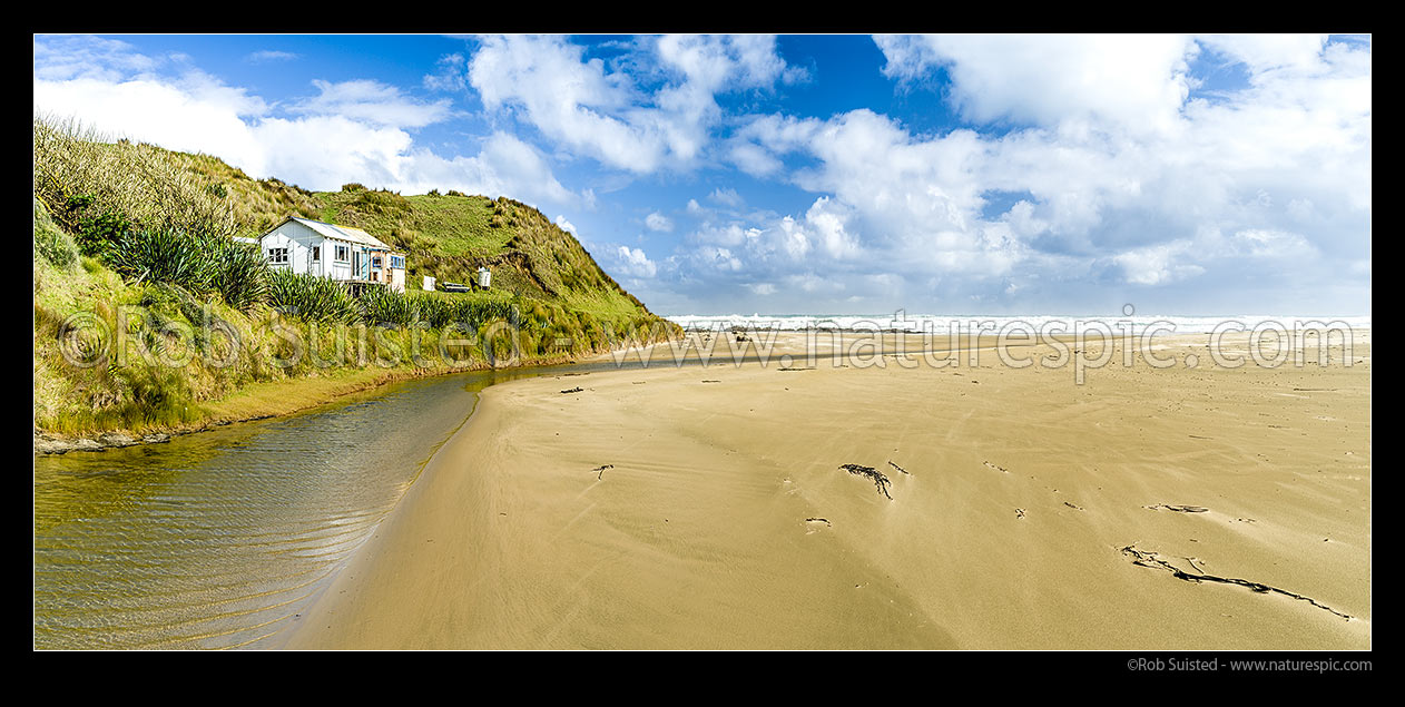 Image of Mitimiti Beach bach looking over golden sands in this isolated piece of Northland Coast. Taikarawa Stream. Panorama, Mitimiti, Far North District, Northland Region, New Zealand (NZ) stock photo image