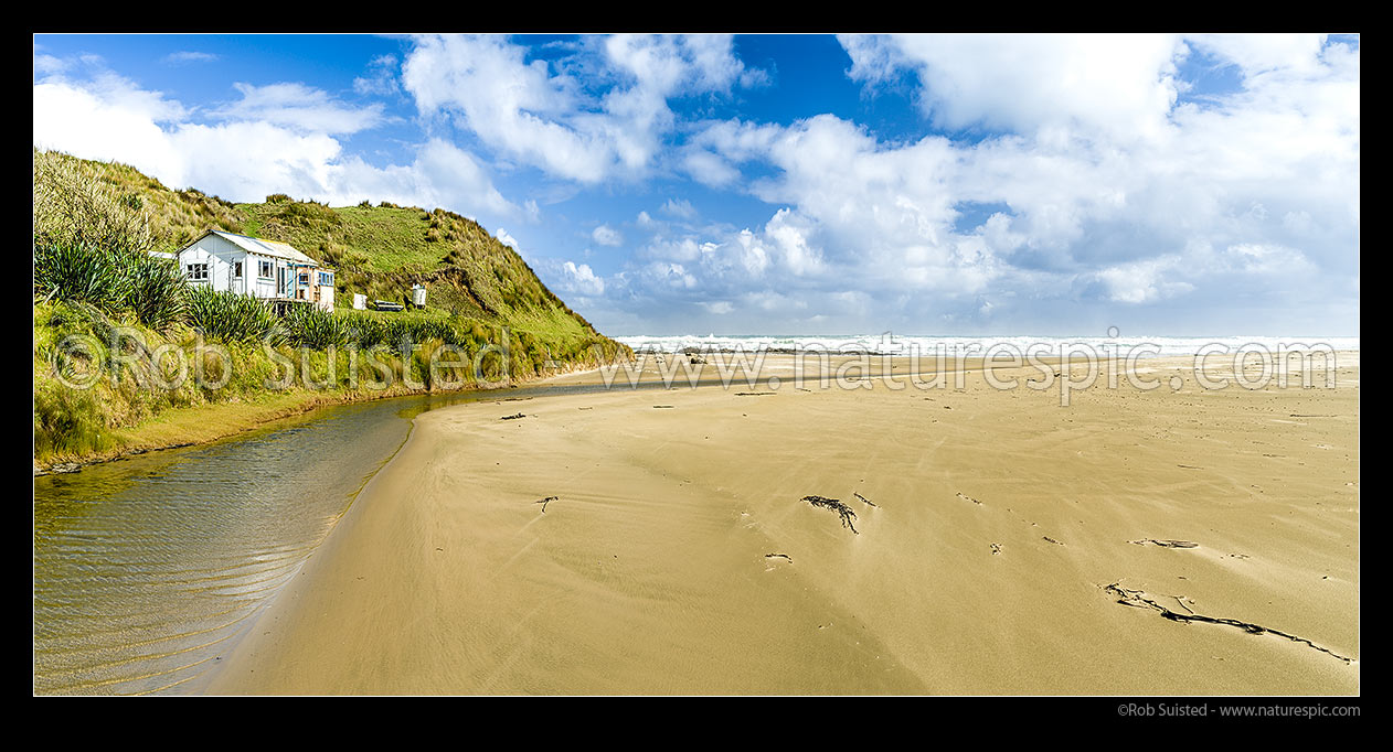 Image of Mitimiti Beach bach looking over golden sands in this isolated piece of Northland Coast. Taikarawa Stream. Panorama, Mitimiti, Far North District, Northland Region, New Zealand (NZ) stock photo image