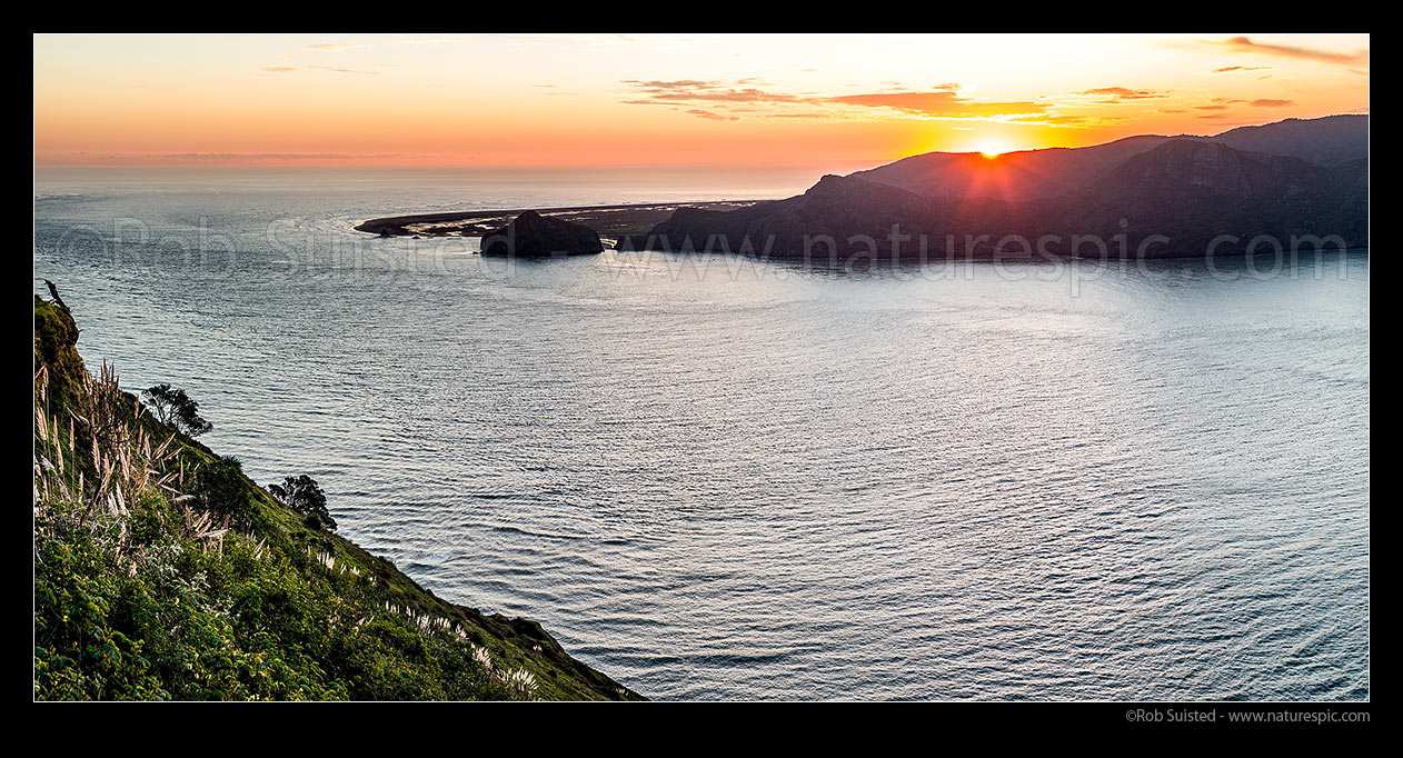 Image of Whatipu Beach and Manukau Harbour entrance with sun setting over the Waitakere Ranges. South Head at left. Panorama, Awhitu Peninsula, Papakura District, Auckland Region, New Zealand (NZ) stock photo image