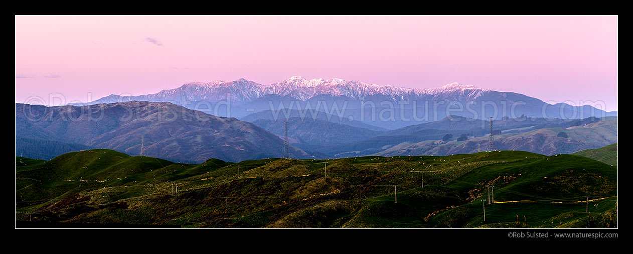 Image of Tararua Ranges, Southern Main Range. Mt Hector (1529m) highest point. Seen from Porirua, at sunset with winter snow. Panorama, Tararua Forest Park, Porirua City District, Wellington Region, New Zealand (NZ) stock photo image