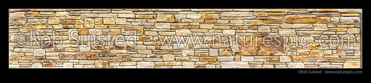 Image of Schist rock wall panorama. Schist rock layered into decorative stone wall. Red schist, New Zealand (NZ) stock photo image