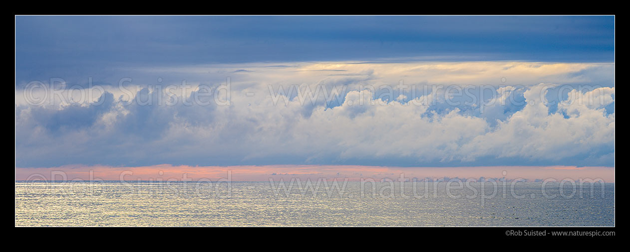 Image of Long white cloud over the moody Tasman Sea. Seen from Bruce Bay on a calm evening. Panorama, South Westland, Westland District, West Coast Region, New Zealand (NZ) stock photo image