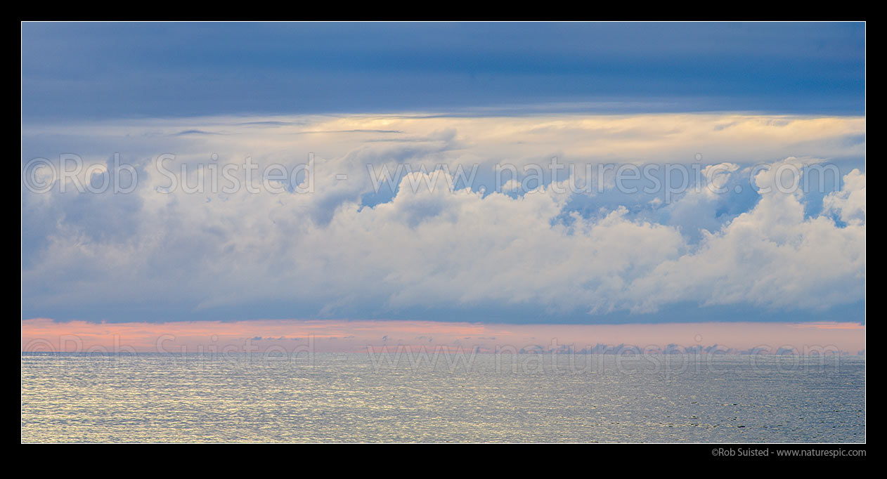 Image of Long white cloud over the moody Tasman Sea. Seen from Bruce Bay on a calm evening. Panorama, South Westland, Westland District, West Coast Region, New Zealand (NZ) stock photo image