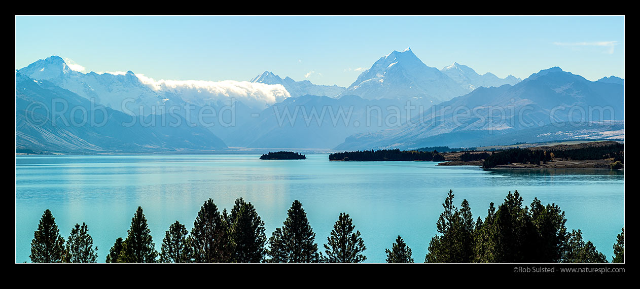 Image of Lake Pukaki and Southern Alps. Aoraki Mt Cook (3754m) centre right. Tasman Valley above Morgans Island.  Mt La Perouse (3078m) centre, Burnett Mountains right. Panorama, Aoraki / Mount Cook National Park, MacKenzie District, Canterbury Region, New Zealand (NZ) stock photo image