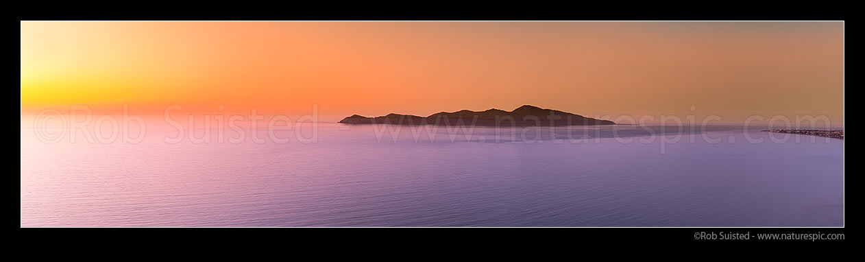 Image of Kapiti Island at sunset. Rauoterangi Channel and Otaheke Strait separate the island 5kms from Paraparaumu Beach. Panorama, Paekakariki, Kapiti Coast District, Wellington Region, New Zealand (NZ) stock photo image