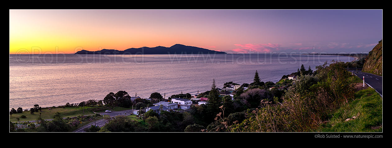 Image of Kapiti Island Nature Reserve offshore from Paekakariki township. Paekakariki Hill Road at right. Paraparaumu and Mt Ruapehu right distance. Panorama, Paekakariki, Kapiti Coast District, Wellington Region, New Zealand (NZ) stock photo image