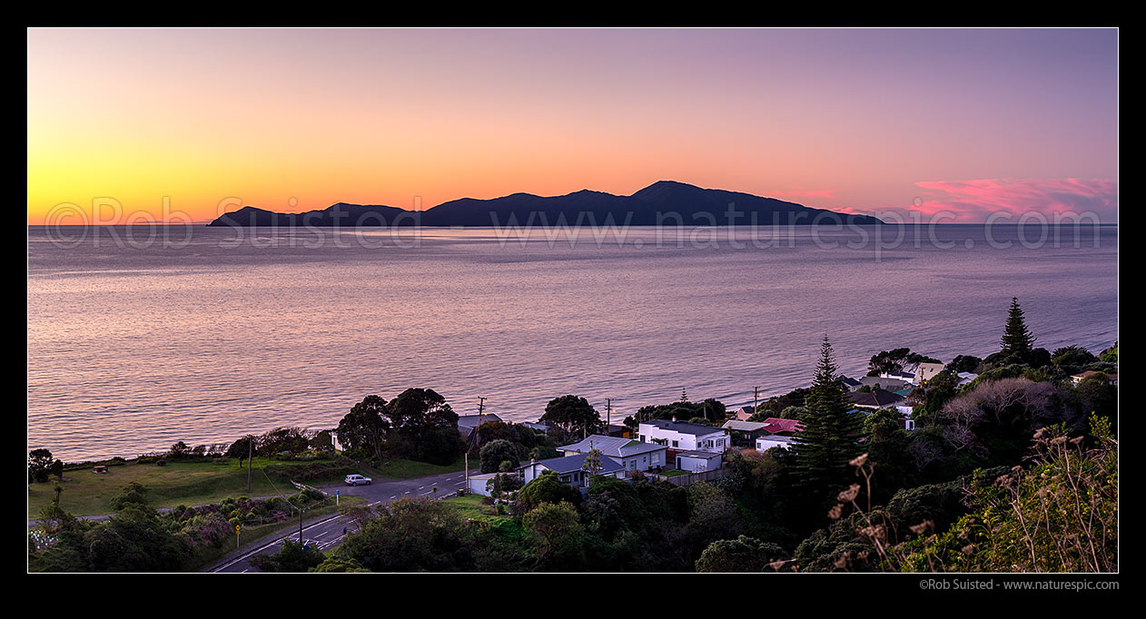 Image of Kapiti Island Nature Reserve and Paekakariki township at dusk. Panorama, Paekakariki, Kapiti Coast District, Wellington Region, New Zealand (NZ) stock photo image